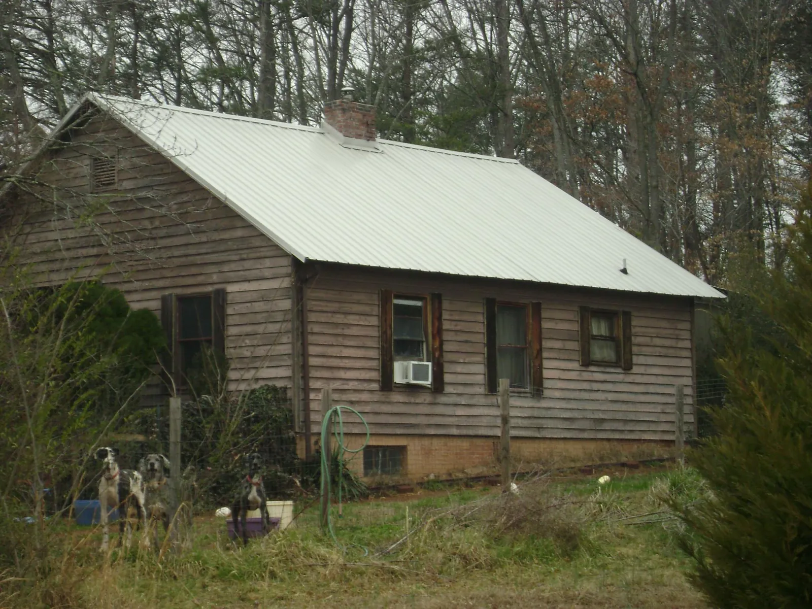 White metal roof on an old wood sided farmhouse, from a Metal Roof Installation job in Binghamton